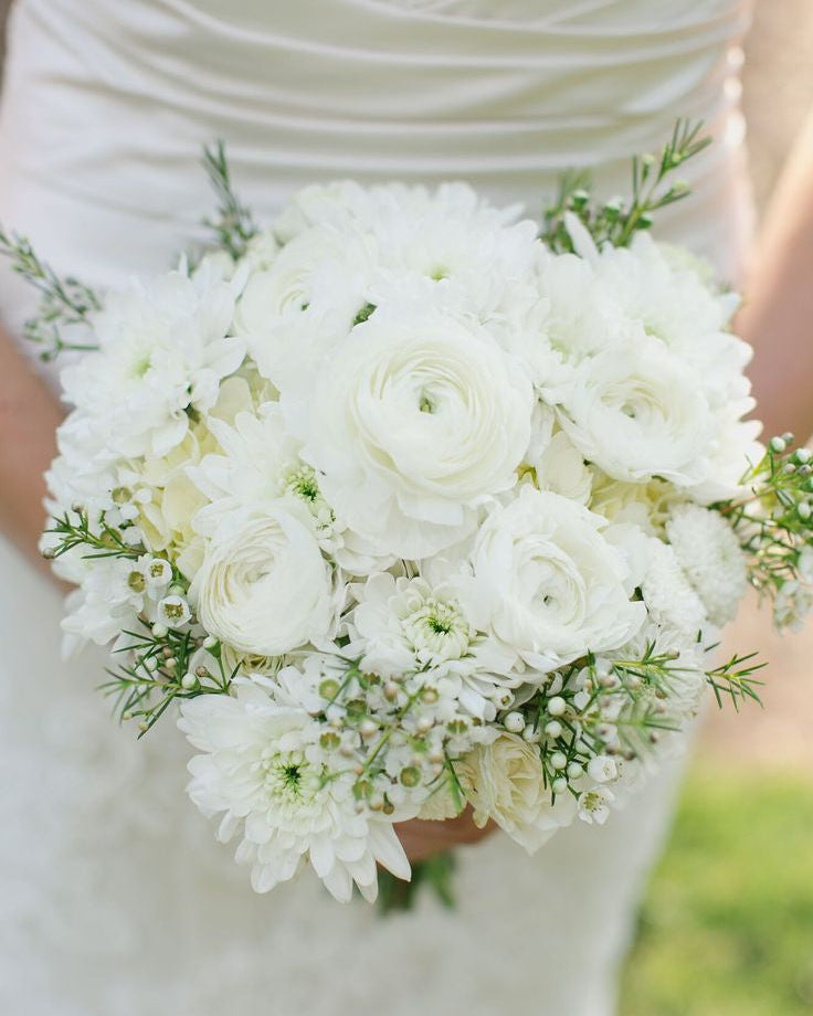 White wedding bouquet with ranunculus, ivory roses, chrysanthemums, waxflower, and lime hydrangea, handcrafted in Miami