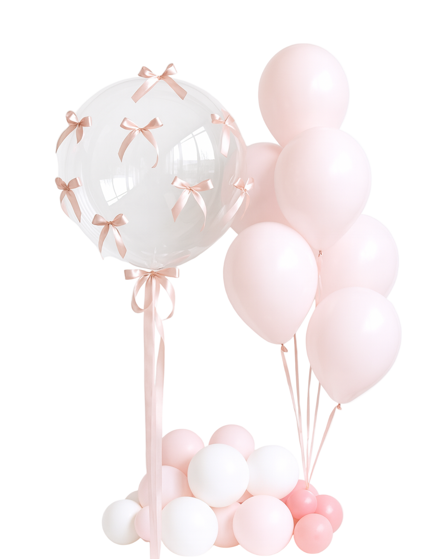 Set of pink and transparent balloons with satin bows on a white background. Elegant gift balloon set for baby girl welcome or celebration.