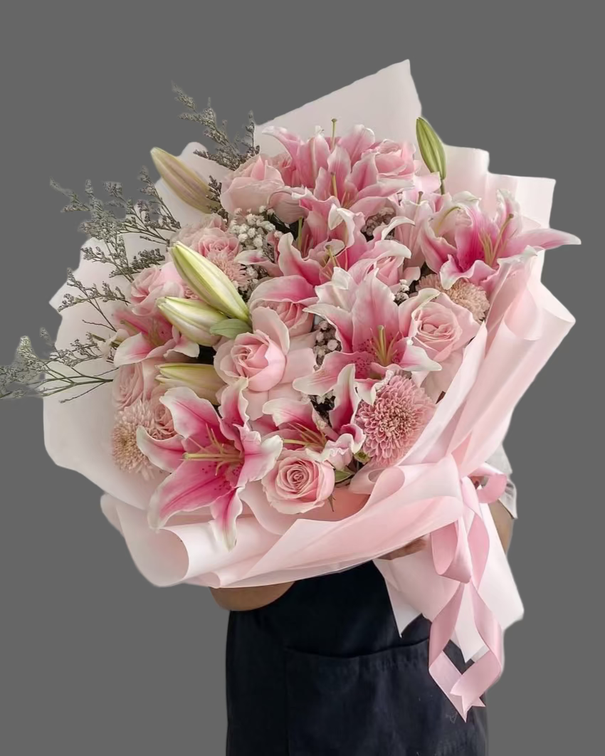 “Elegant floral arrangement of pink lilies and roses with satin ribbons, premium flower delivery Sunny Isles Beach and Aventura”