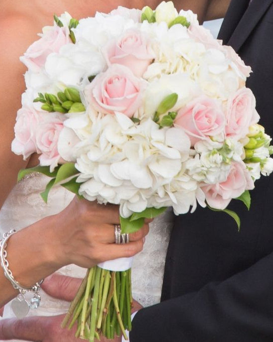 Wedding bouquet with white hydrangea, pink and ivory roses, and white matthiola, handcrafted in Miami