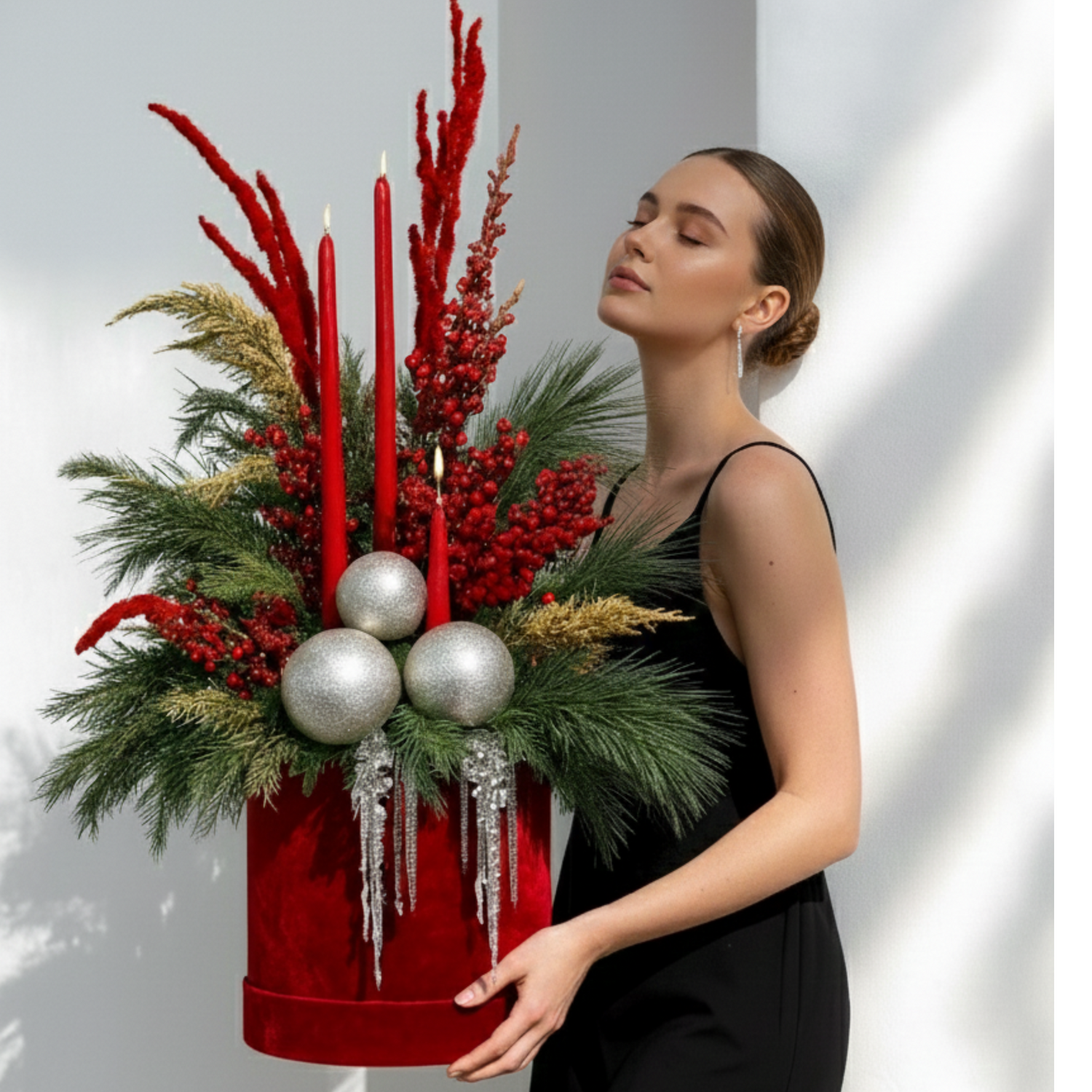 Luxury Christmas floral arrangements with natural greenery and festive accents in a modern studio setting.