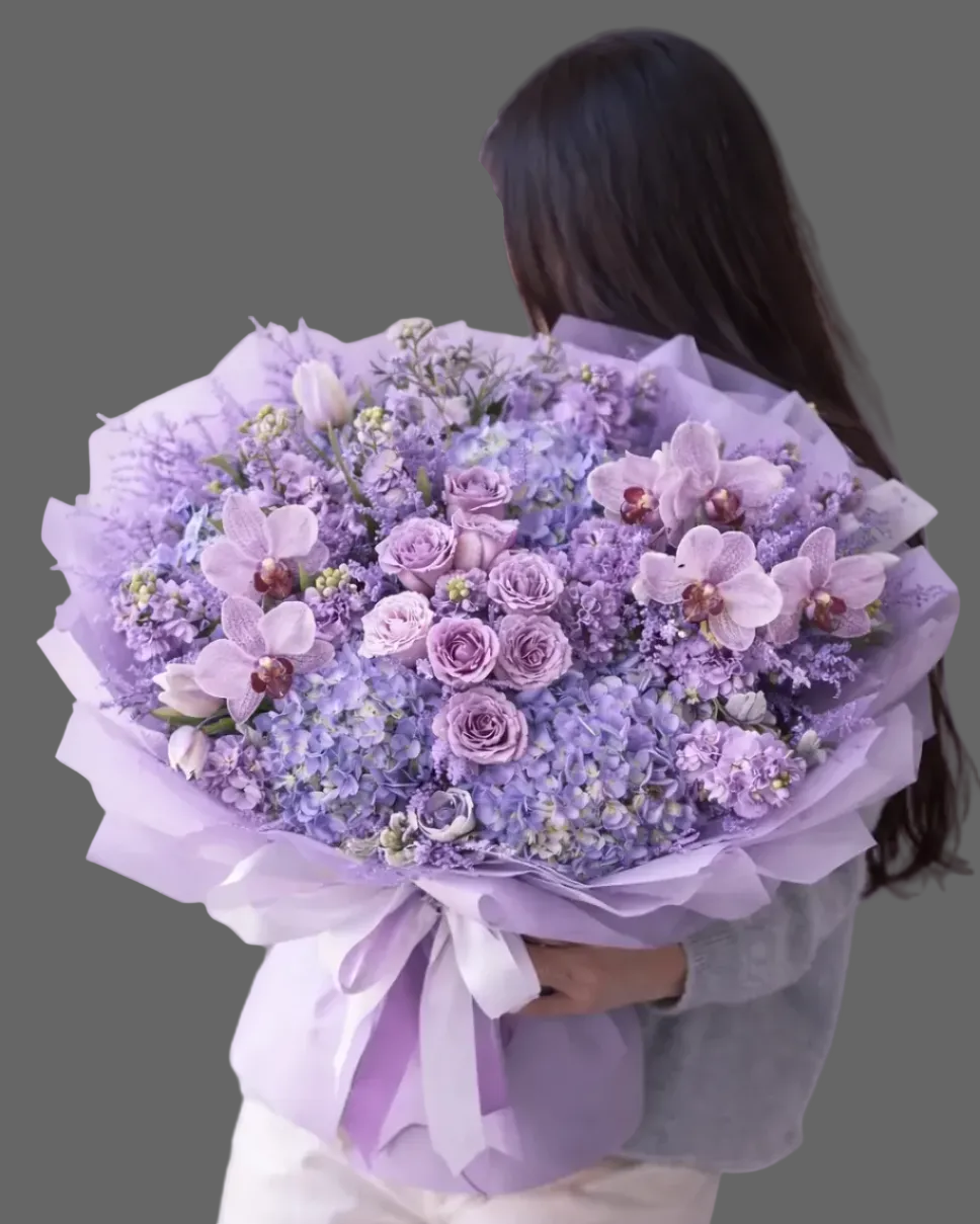 Purple Rain bouquet with hydrangeas, roses, orchids, matthiola, and wax flower fillers in soft purple and lavender tones, fresh flower arrangement ready for delivery in Miami and nearby areas