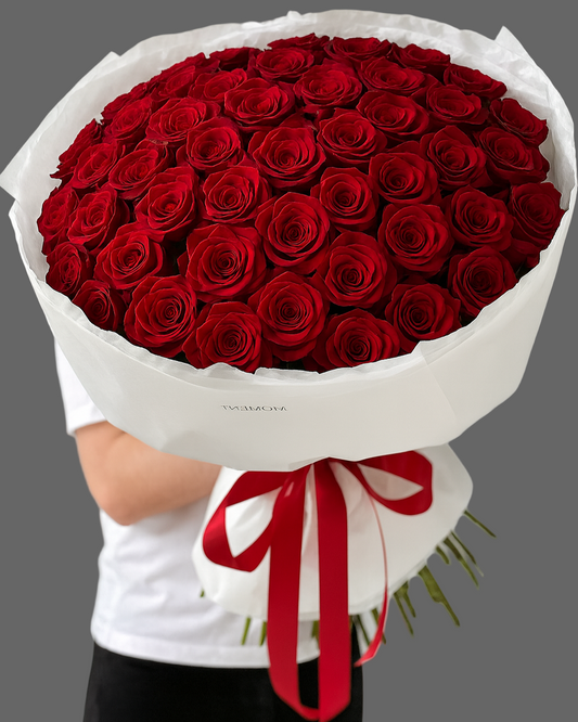 “THE MOMENT bouquet with premium red roses in elegant white wrapping and red ribbon, romantic bouquet for delivery in Miami and Sunny Isles.”