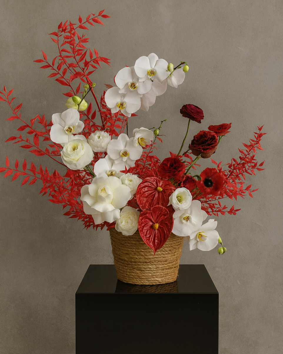 Luxury flower basket “Opulent Charm” with white orchids, red anthuriums, ranunculus, and roses in a natural wicker basket. Elegant floral arrangement for weddings, anniversaries, and special occasions. Premium flower delivery Miami, Sunny Isles, Aventura, Hallandale, Hollywood