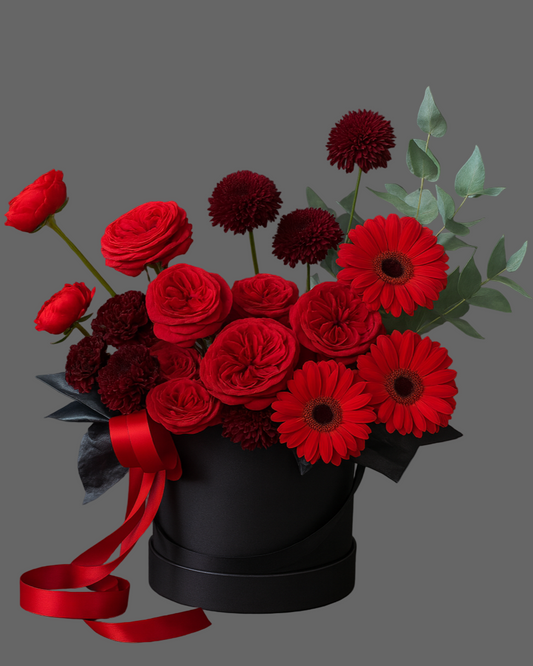 Luxury black hatbox with Red Piano roses, burgundy chrysanthemums, gerbera, and eucalyptus – premium flower arrangement Miami.
