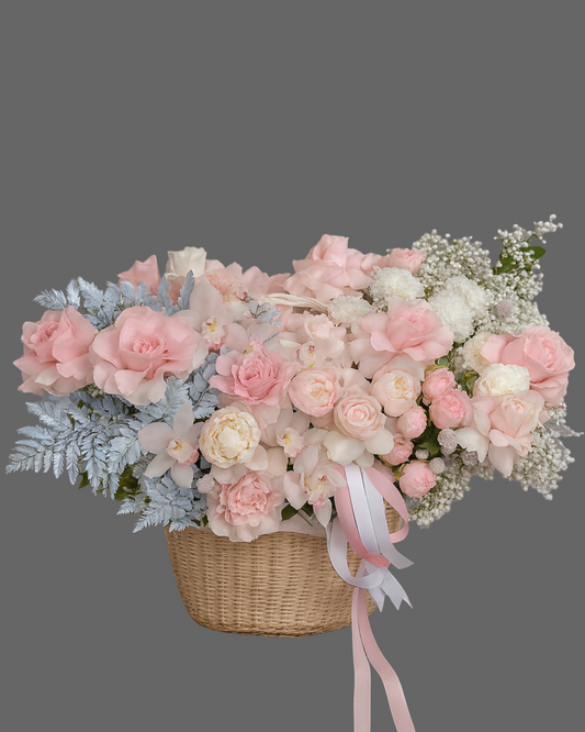 Soft pink and silver flower basket with roses, peonies, orchids, and silver fern. Elegant luxury floral arrangement for weddings, baby showers, and gifts in Miami.