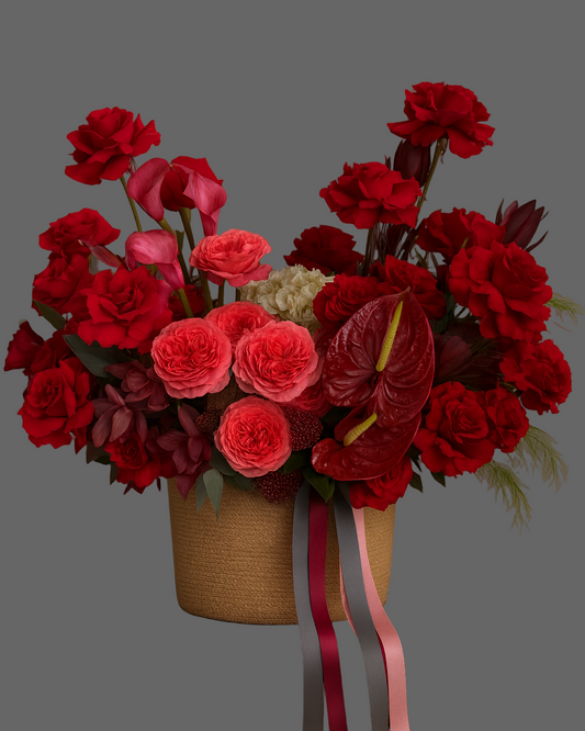 Ruby Silk basket with red roses, anthuriums, and spray roses — luxury floral arrangement for romantic gifts and anniversaries in Miami.