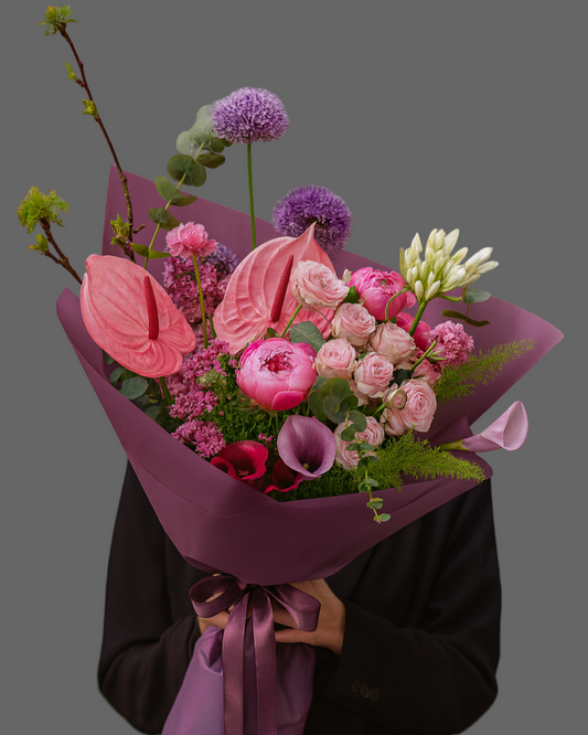 Bouquet June Allure with pink anthurium, peonies, garden roses and calla lilies in purple wrapping, luxury flowers with delivery in Miami and Sunny Isles.