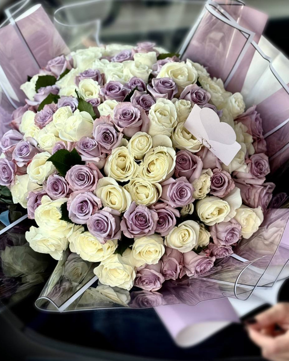 Close-up of 100 white and lavender roses highlighting fresh petals and elegant color harmony