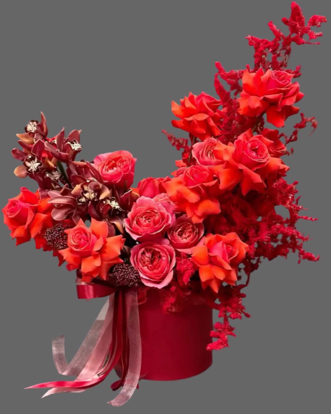 Premium arrangement “Red Couture” with vibrant red roses and exotic orchids in a luxury hat box. Perfect romantic flower gift for Valentine’s Day, anniversaries, and special occasions. Available in multiple sizes with same-day Miami flower delivery.