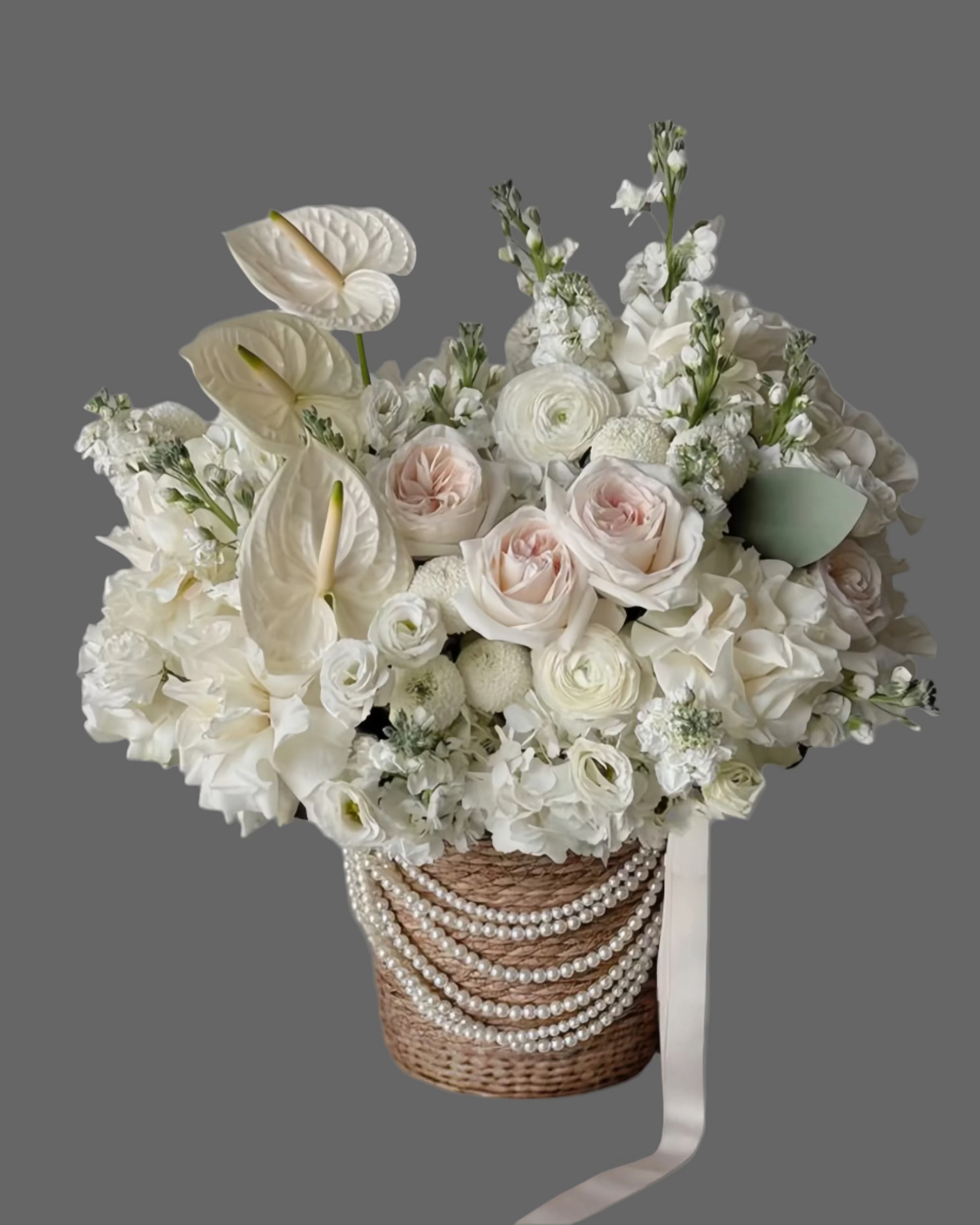 Exotic White Elegance flower basket with roses, hydrangea, and anthurium in luxury white tones. Premium flower arrangement for weddings, anniversaries, and events in Miami.
