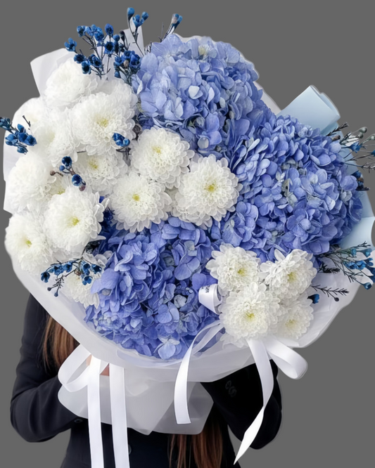 Bouquet The Wave with blue hydrangea and white chrysanthemums, ocean-inspired luxury flowers, available for same-day delivery in Miami and Sunny Isles.”
