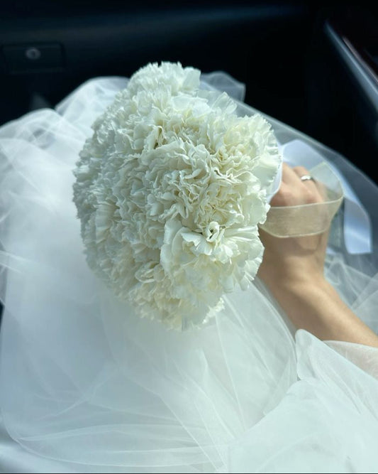Round white dianthus wedding bouquet with satin ribbon handle, handcrafted in Miami
