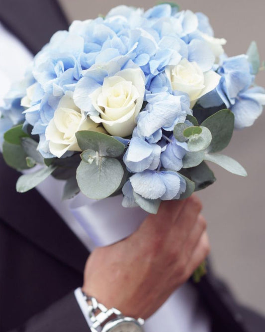 Wedding bouquet with blue hydrangea, white roses, and eucalyptus, handcrafted in Miami
